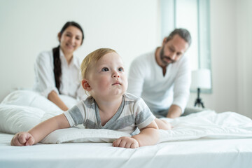 Obraz premium Portrait of Caucasian happy family smiling, look at camera in bedroom. 