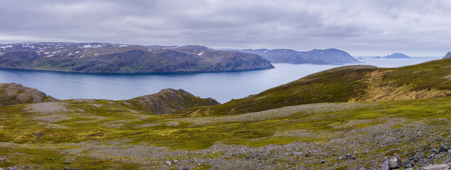 panorama image of a landscape with fjord and mountains on the isle of Mageroya in northern Norway