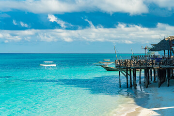 Fishing ship and boats near the beach of Indian ocean in the morning. Zanzibar, Tanzania
