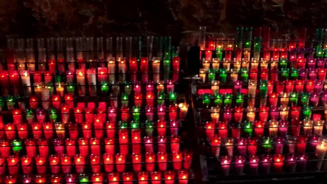 Cave adit of the monastery with a platform for candles.
Lots of burning candles in Montserrat. Mount Montserrat in Spain. The famous monastery of Montserrat. Jagged mountain