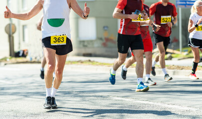 Marathon running race, people feet on road.