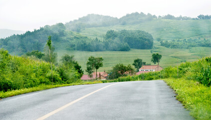 Asphalt road  leading  to the mountain village in China