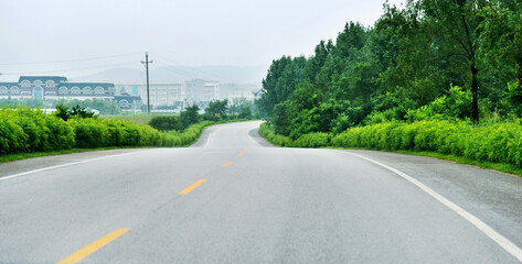 Asphalt road  leading  to the mountain village in China