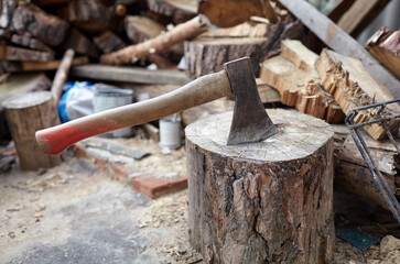 Ax in the stump. Axe for cutting wood. Preparation of firewood for the winter. Selective focus, blurred background