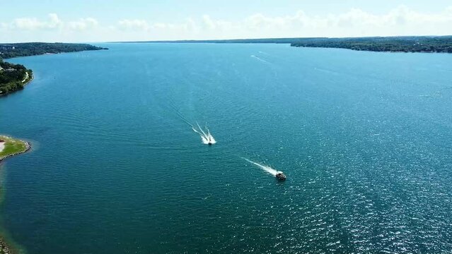 Motorboats speeding through choppy Clear Blue Water on  Lake Simcoe in Barrie, Ontario