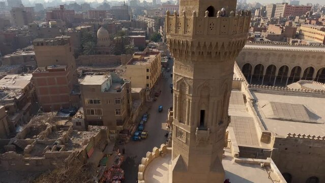 Minaret of the Bab Zuweila gate, tilt down revealing busy street, Cairo City