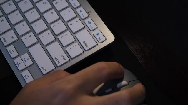 Hand Working On Desk With Wireless Computer Mouse And Keyboard. overhead