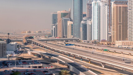 Naklejka na ściany i meble Dubai Marina skyscrapers and Sheikh Zayed road with metro railway aerial timelapse, United Arab Emirates