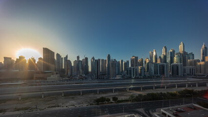 Naklejka na ściany i meble Panorama of Dubai marina tallest block of skyscrapers timelapse during sunset.