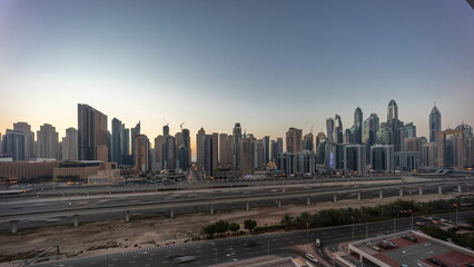 Naklejka na ściany i meble Dubai marina tallest block of skyscrapers day to night timelapse.