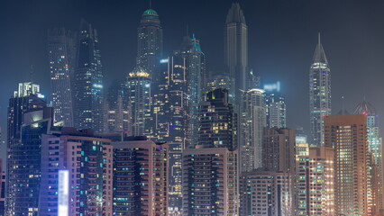 Fototapeta na wymiar Dubai marina tallest block of skyscrapers night timelapse.