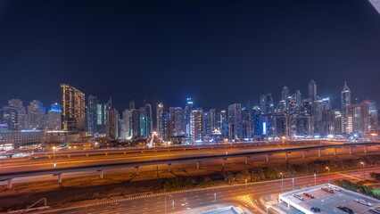 Panorama of Dubai marina tallest block of skyscrapers all night timelapse.