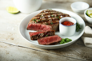 Grilled beef steak with tomato sauce