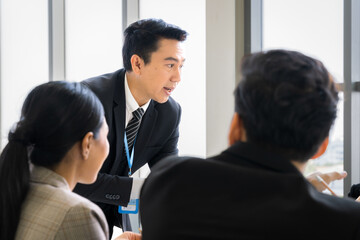 new business group Asians are meeting with determination and seriousness in company conference room. The idea is Finance, Marketing, Accounting.