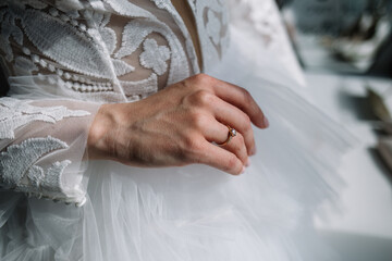 Gold wedding rings are on the bride's hand