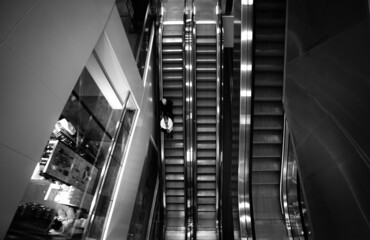 escalator in shopping mall black and white