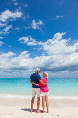 Happy male female in casual clothes on beach