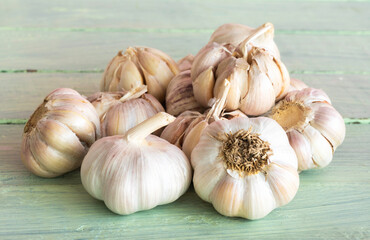 Garlic bulbs on old wooden background.