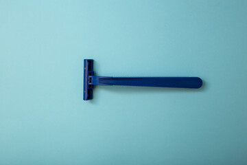 Disposable shaver razor isolated on blue background