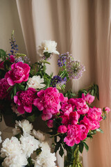 Beautiful floral background. Floral composition of fresh pink and white peonies as a decoration in the room.