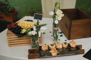 Catering banquet table at wedding reception. Restaurant presentation, european cuisine, food consumption, party concept. Food styling, appetizers bar, welcome drink, event design.