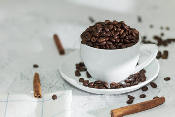 White cup and saucer with fragrant coffee beans