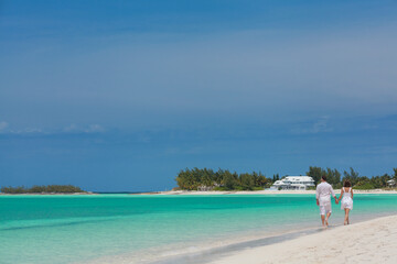 Romantic Caucasian couple walking on  beach for relaxation