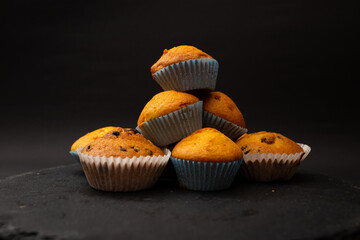 Juicy cupcakes on a black background, confectionery, bakery