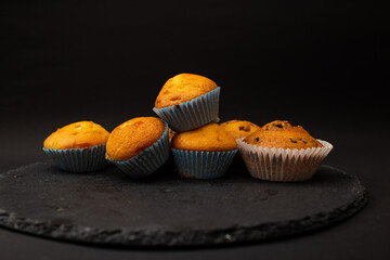 Juicy cupcakes on a black background, confectionery, bakery