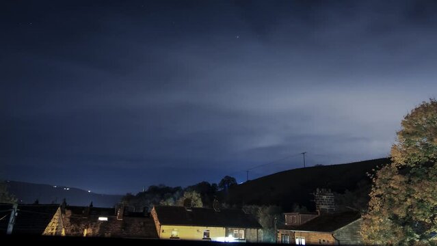 clouds stars and country side , night passing by in the small town of todmorden