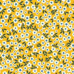 Seamless vintage pattern. small white flowers, green leaves. yellow background. vector texture. fashionable print for textiles, wallpaper and packaging.