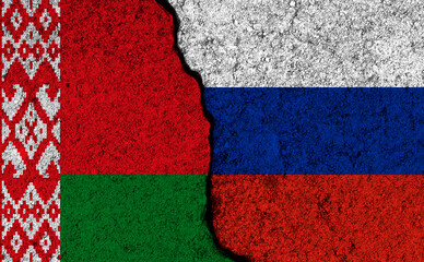 Belarus and Russia, sanctions concept background. Flags painted on cracked concrete wall photo