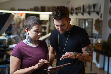 Two caucasian people with tattoo discussion about new project