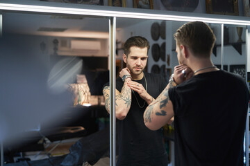 Caucasian man checking what the tattoo looks like