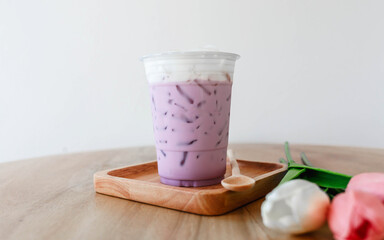 Iced taro tea with milk in a plastic cup - obrazy, fototapety, plakaty