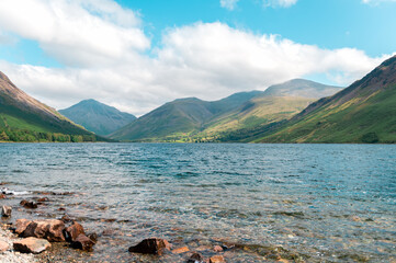 Fototapeta na wymiar Wast Water or Wastwater is a lake located in Wasdale, a valley in the western part of the Lake District National Park, England, UK, beautiful summer day and blue cloudy sky