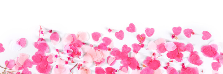 Obraz na płótnie Canvas Valentine day or wedding panorama with pink hearts and flowers confetti, a flat lay panoramic banner on a white background with a place for text