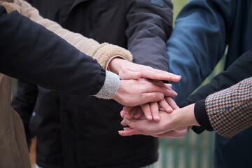 Multi-ethnic group of friends with hands in stack. Teamwork concept.