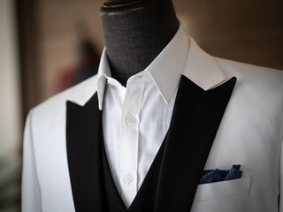 Close up of white tuxedo jacket with black satin collar 