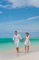 Healthy Caucasian couple walking by sea on holiday