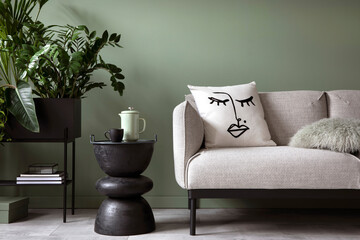 Stylish composition of living room interior. Modern sofa, design pillows, plants in metal pot and creative personal accessories. Eucalyptus green wall. Template. Copy space.