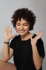 Afro curly hair fashion woman, natural makeup and cosmetics. Beauty face smile portrait of a woman with black curly hair, afro hairstyle. Curls