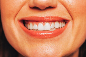 Close up portrait of young happy smiling woman with red lips. Cheerful Youngster face shot with perfect smile.