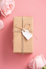Mother's Day design concept background with pink rose flower and gift on pink background.