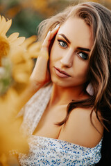 Naklejka premium beautiful girl in a sunflower field