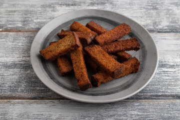 toast on a gray plate on a gray wooden background. Side view.