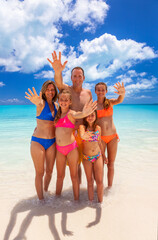 Portrait of Caucasian parents and daughters on beach