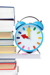 Light blue alarm clock and different books on white background. School time