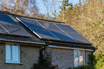 A countryside house that has had solar panels installed on the roof to produce clean green...