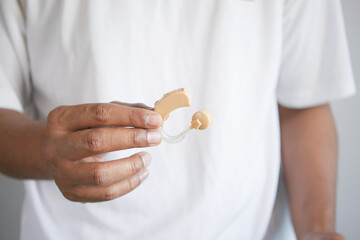 Hearing aid concept, a young man with hearing problems.